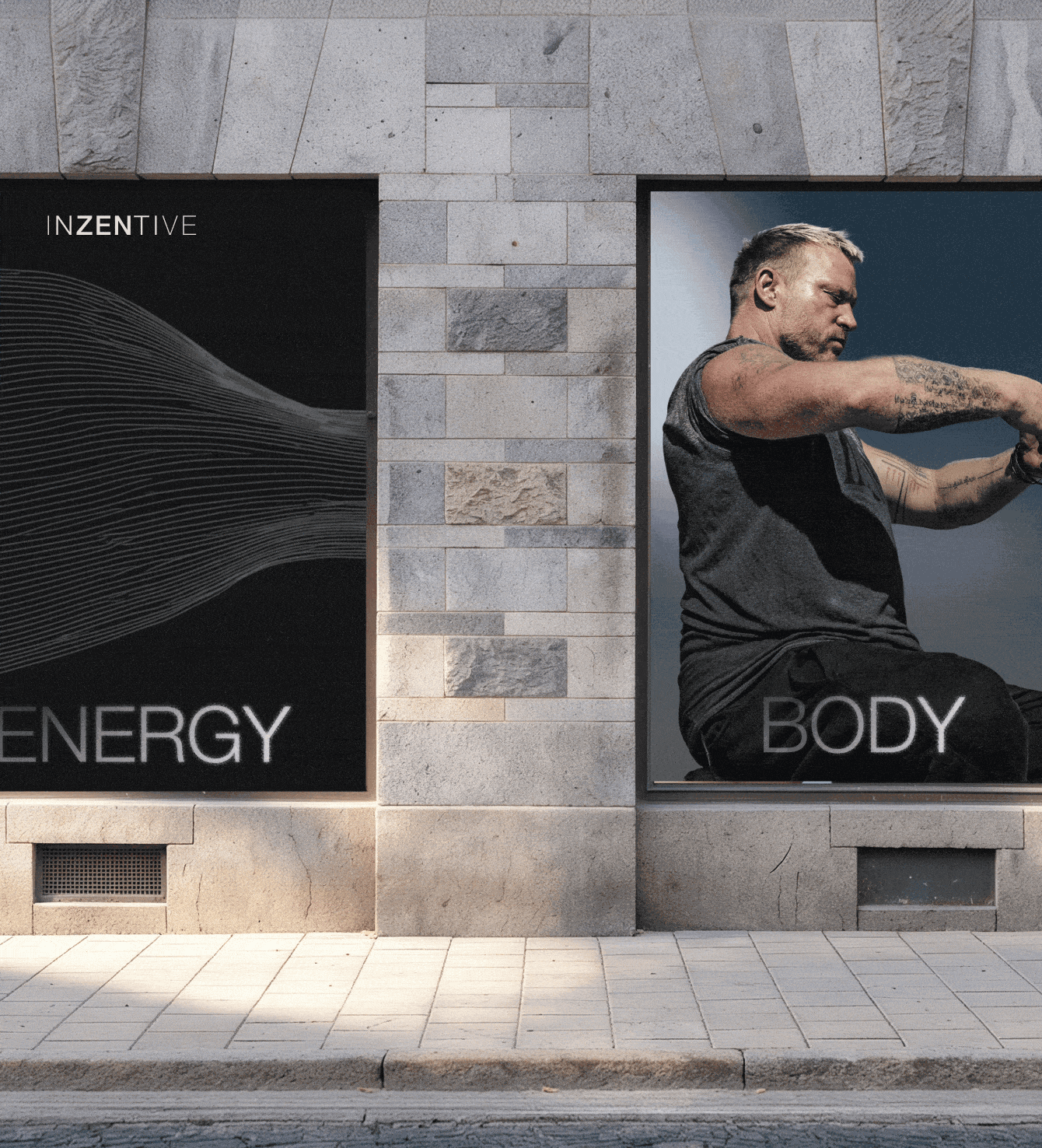 Street-level billboard ads reading "ENERGY" and "BODY" featuring a tattooed man mid-stretch, mounted on a stone building.