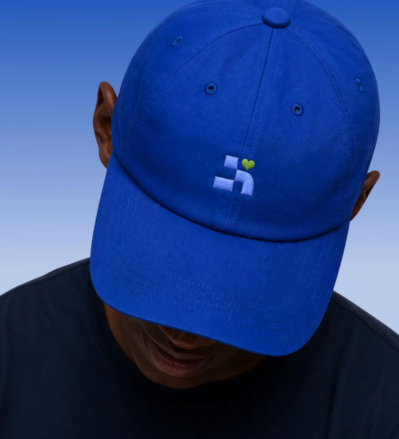 Close-up of a blue baseball cap embroidered with the Nowlii logo.