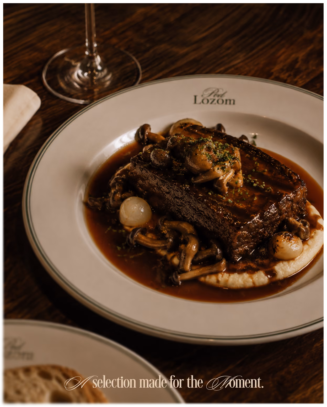 Braised short rib dish on a Pod Lozom branded plate.
