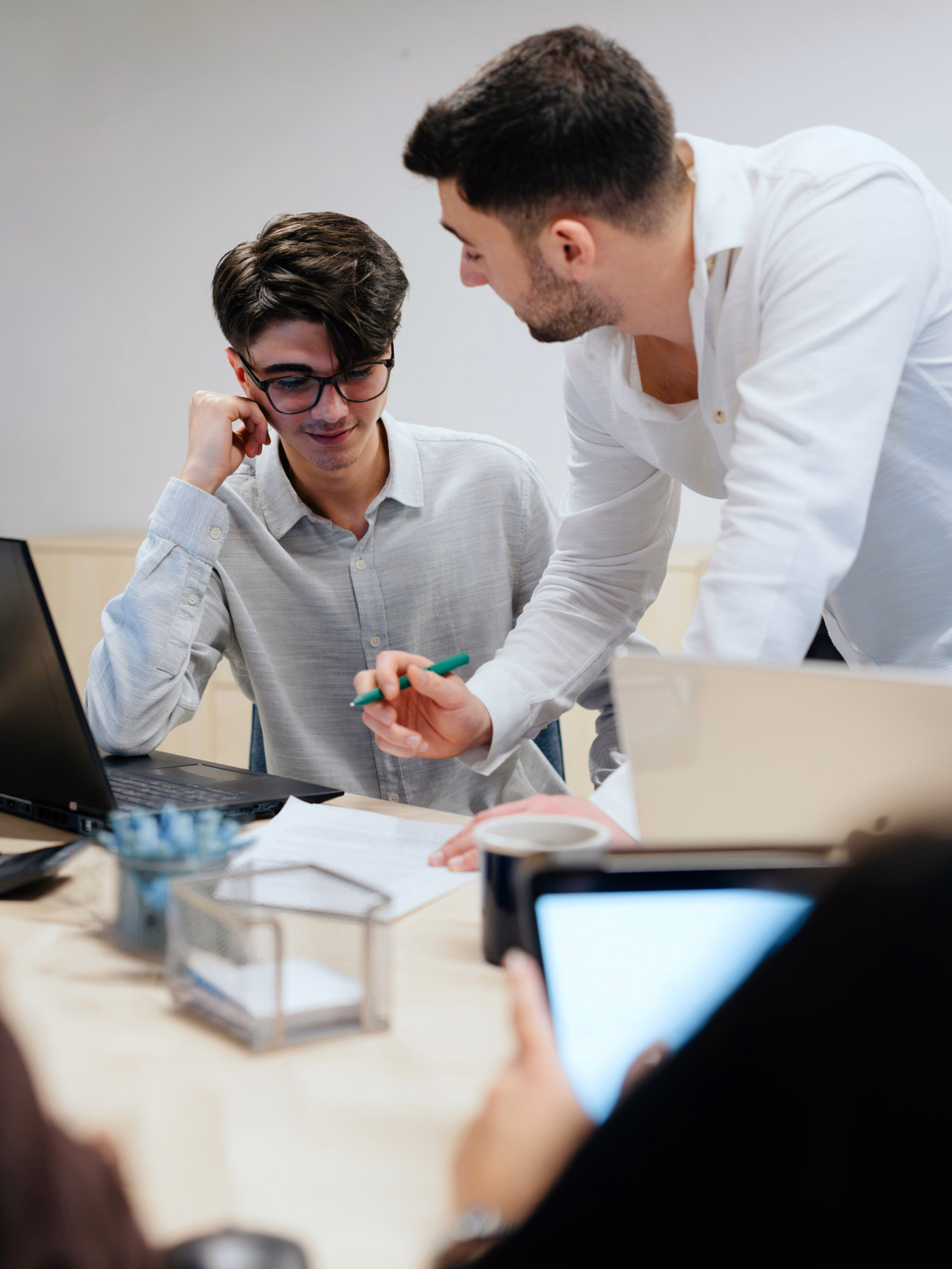 Colleagues reviewing work together at a desk