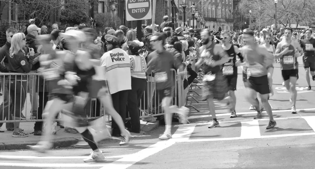 Marathon runners crossing a city street