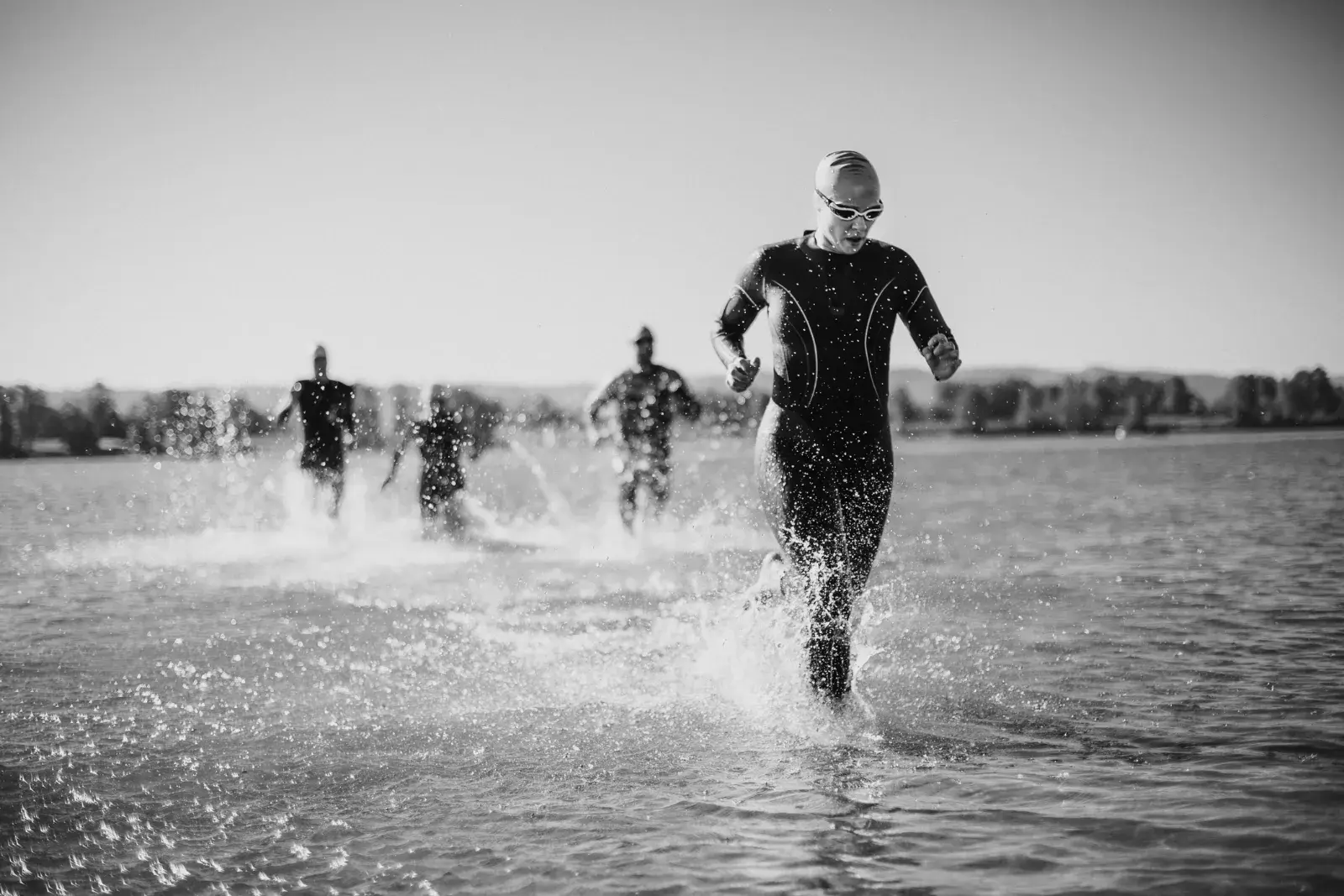 Triathletes running out of the water