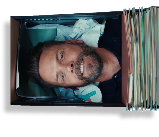 An auditor grinning up from inside a filing drawer