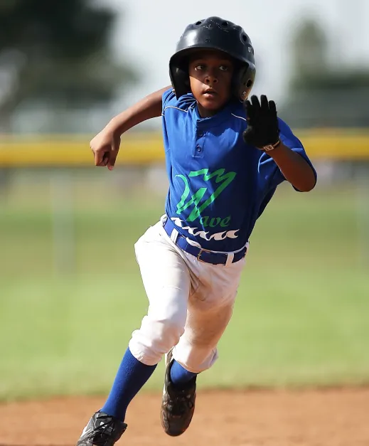 young boy, playing baseball running from a base