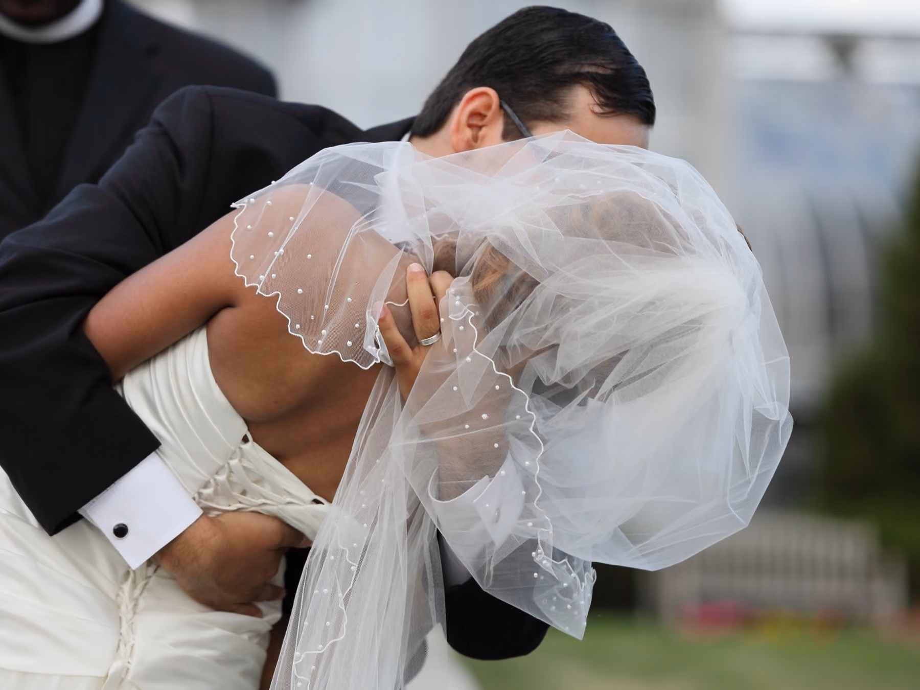 Wedding couple sharing a kiss by Fullerton Photography