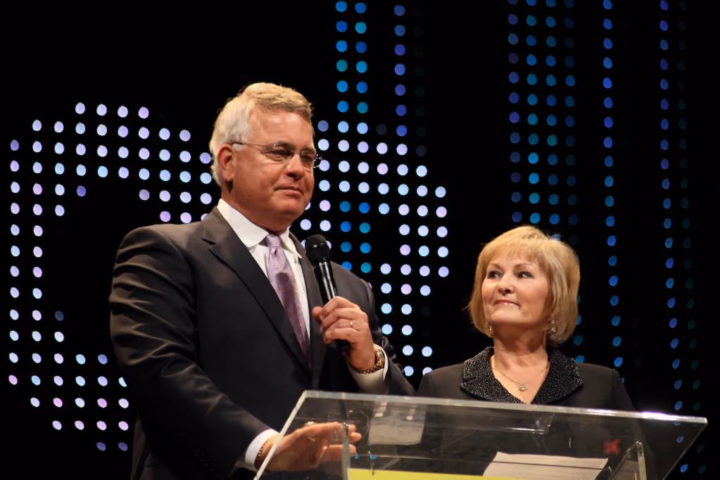 Speaker presenting at a podium during an event