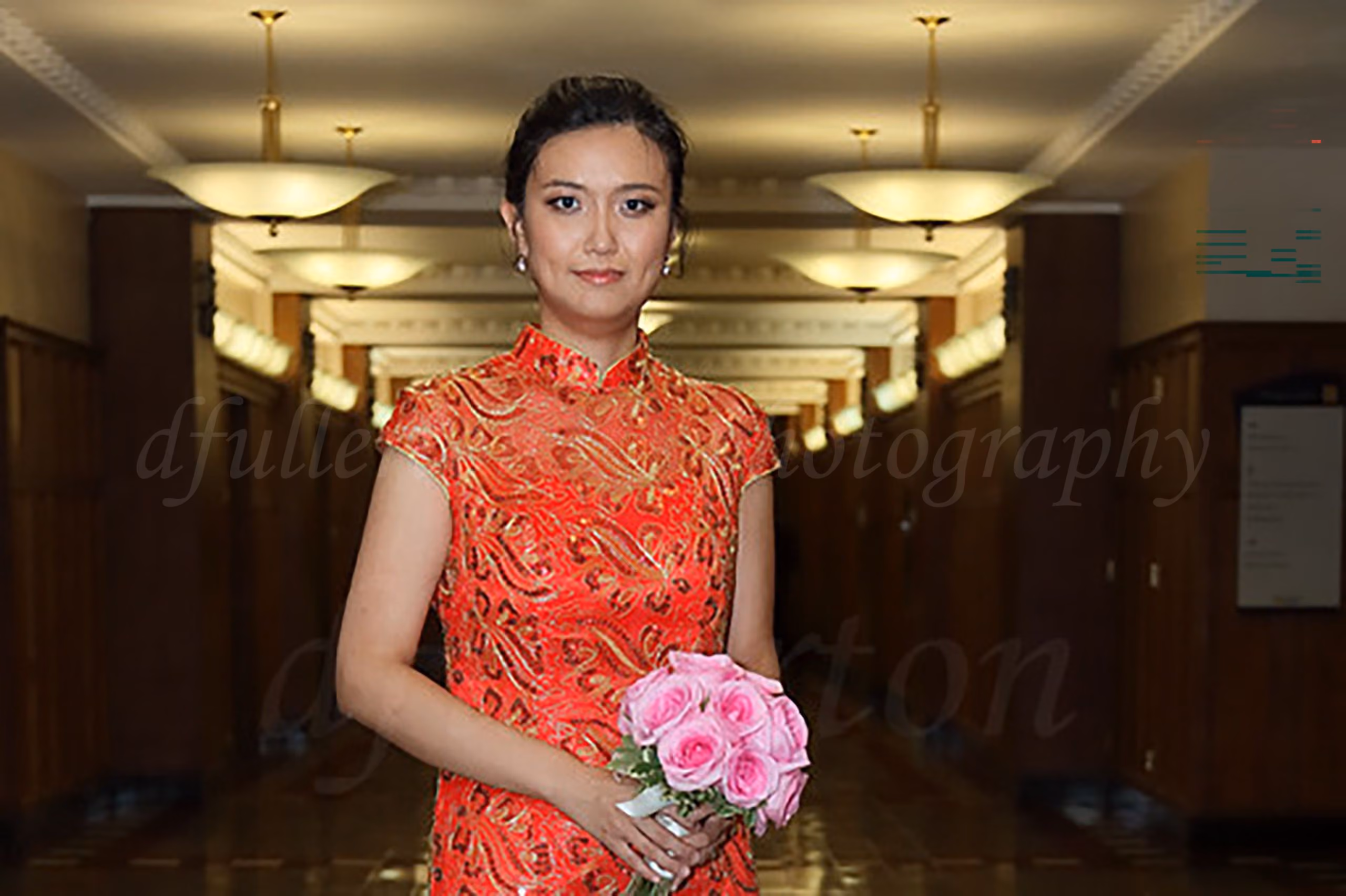 Bride in a red traditional qipao dress holding pink roses, portrait by Fullerton Photography