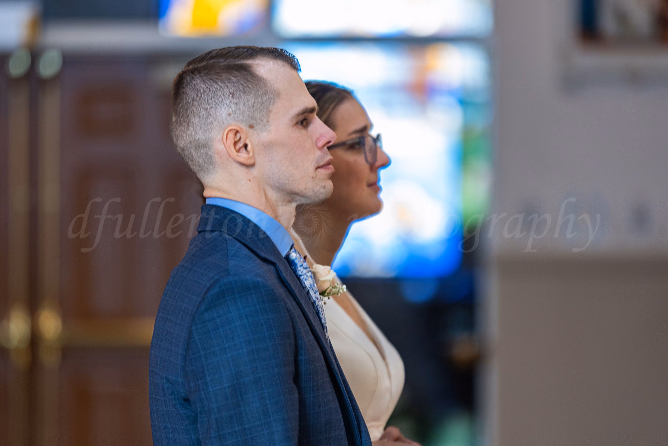 Profile portrait of groom and bride during their wedding ceremony.