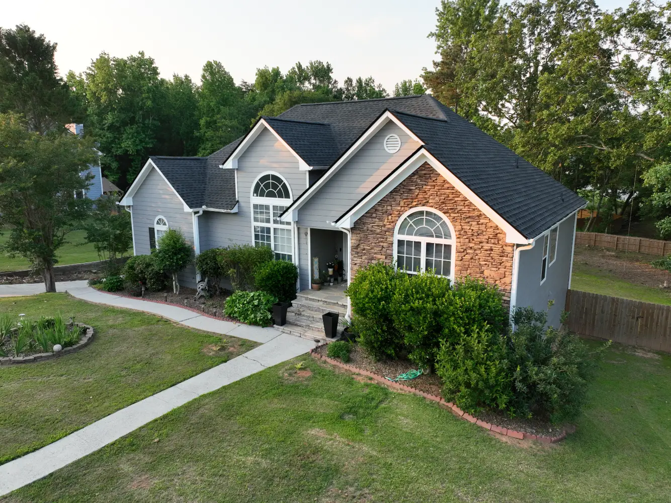 A completed residential roof replacement in Buford, Georgia, by Douglas Construction, a trusted residential roofing contractor. The home features a durable, high-quality roof with expertly installed shingles.