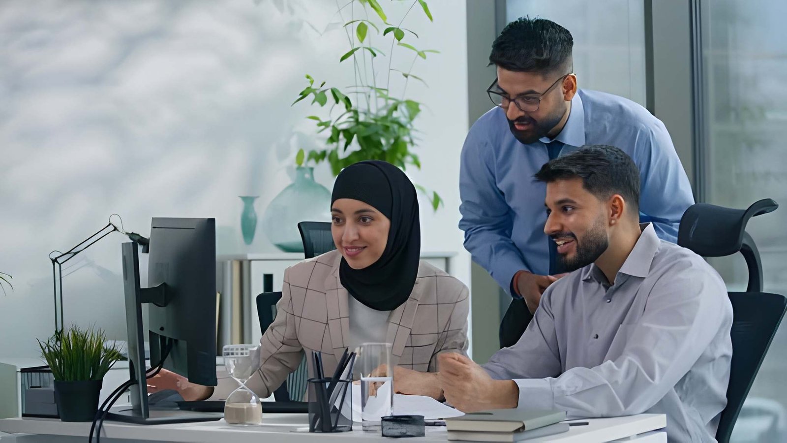 Muslim professionals discussing mental health and wellbeing support in a modern office