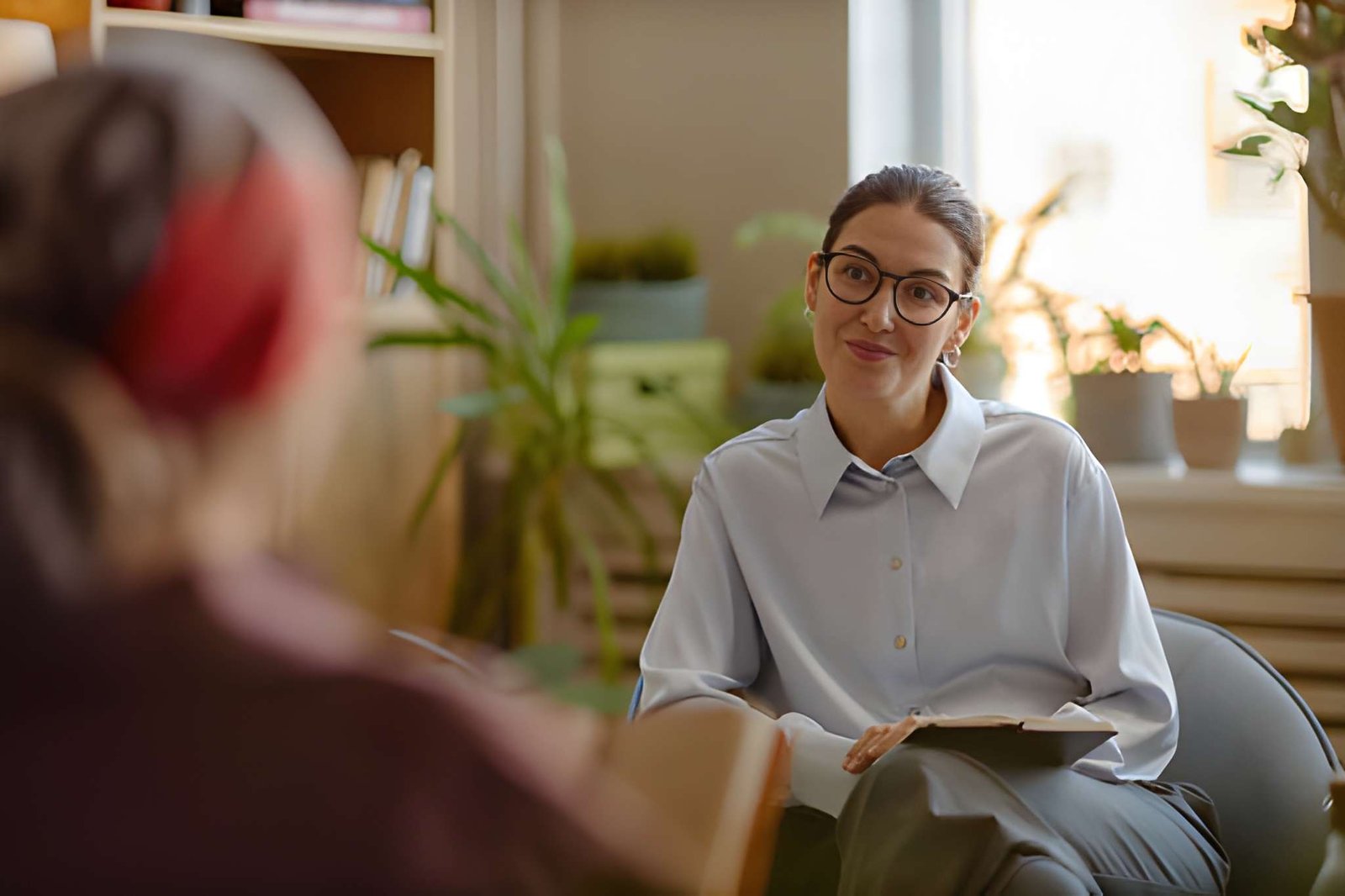 Female counsellor speaking with a client during a therapy session