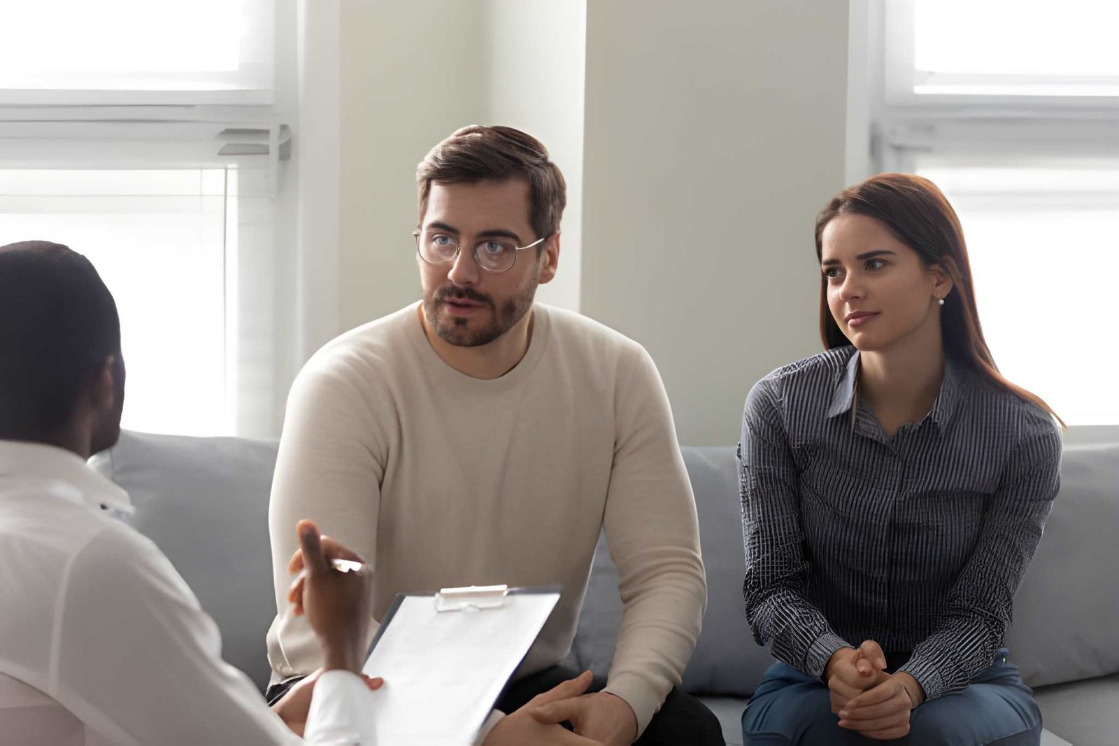 Marriage counsellor speaking with a couple during a therapy session