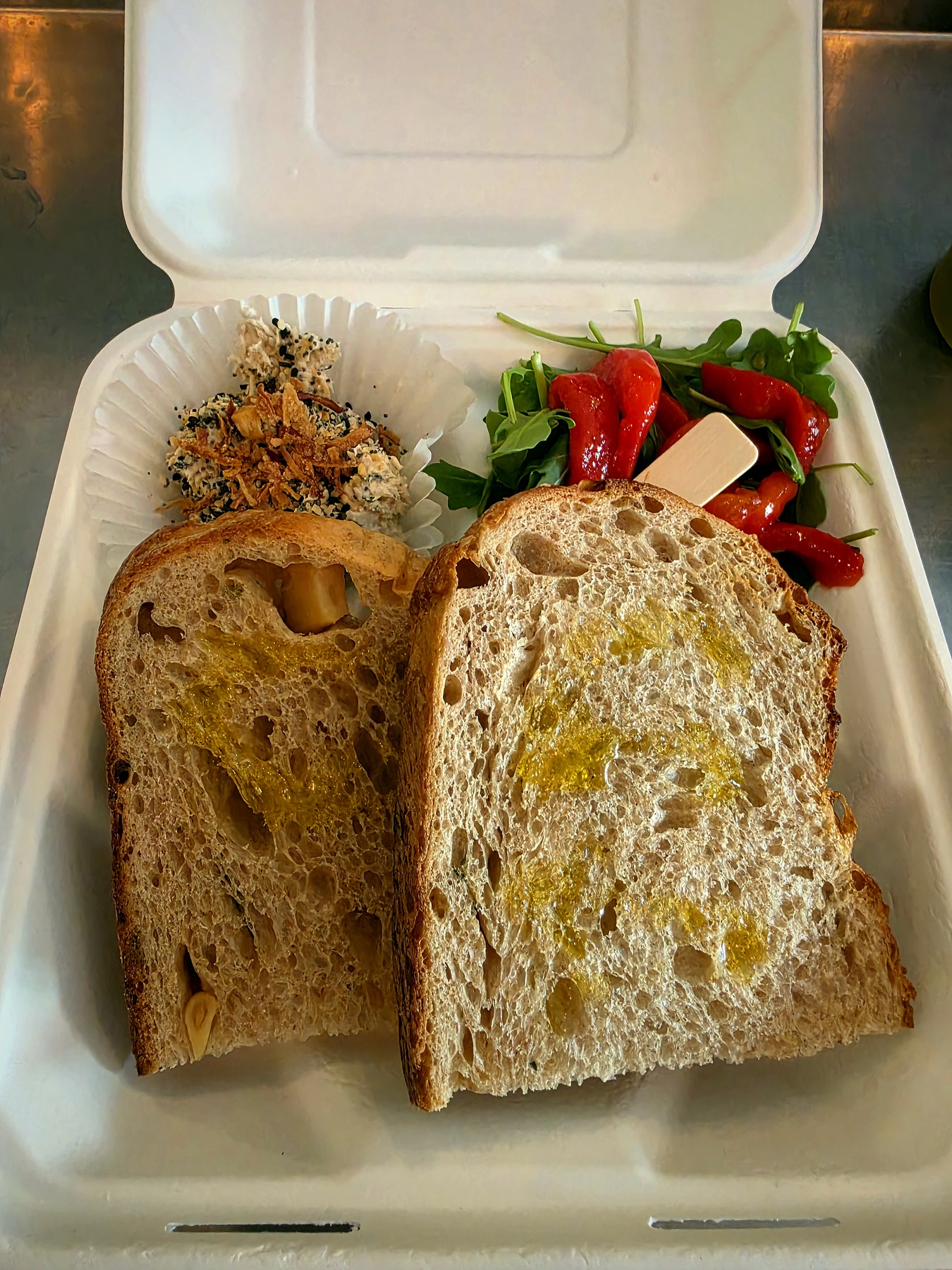Sourdough, whipped spread, arugula and roasted red pepper served deconstructed in a SBREAD to-go box