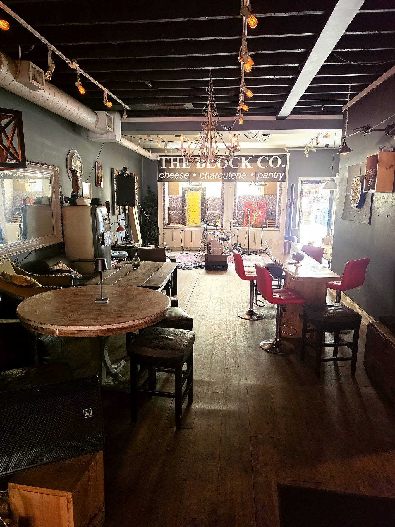 Lounge area with seating and room for a live band at The Block Co.