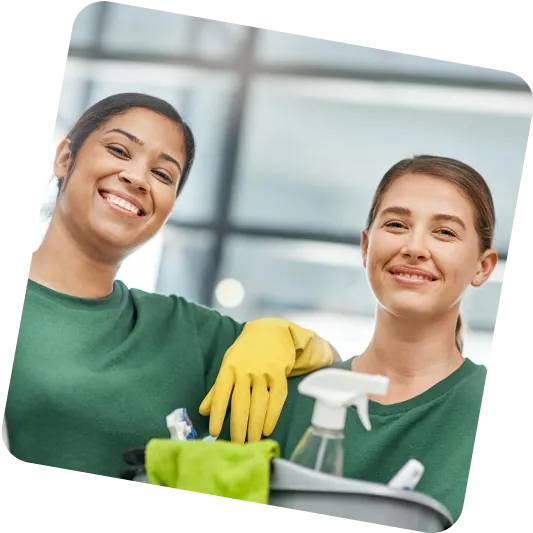 Two team members with cleaning supplies