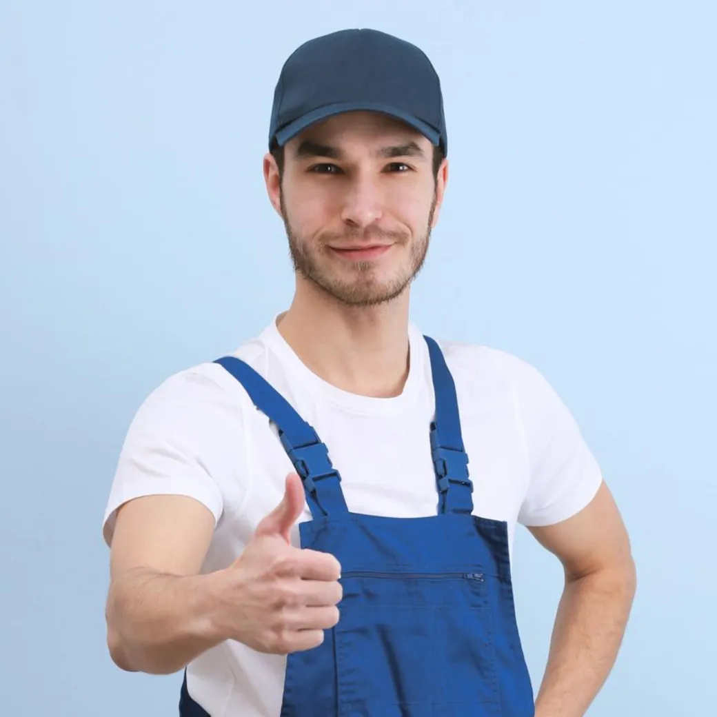 Crisp Restoration technician in work overalls giving a thumbs up