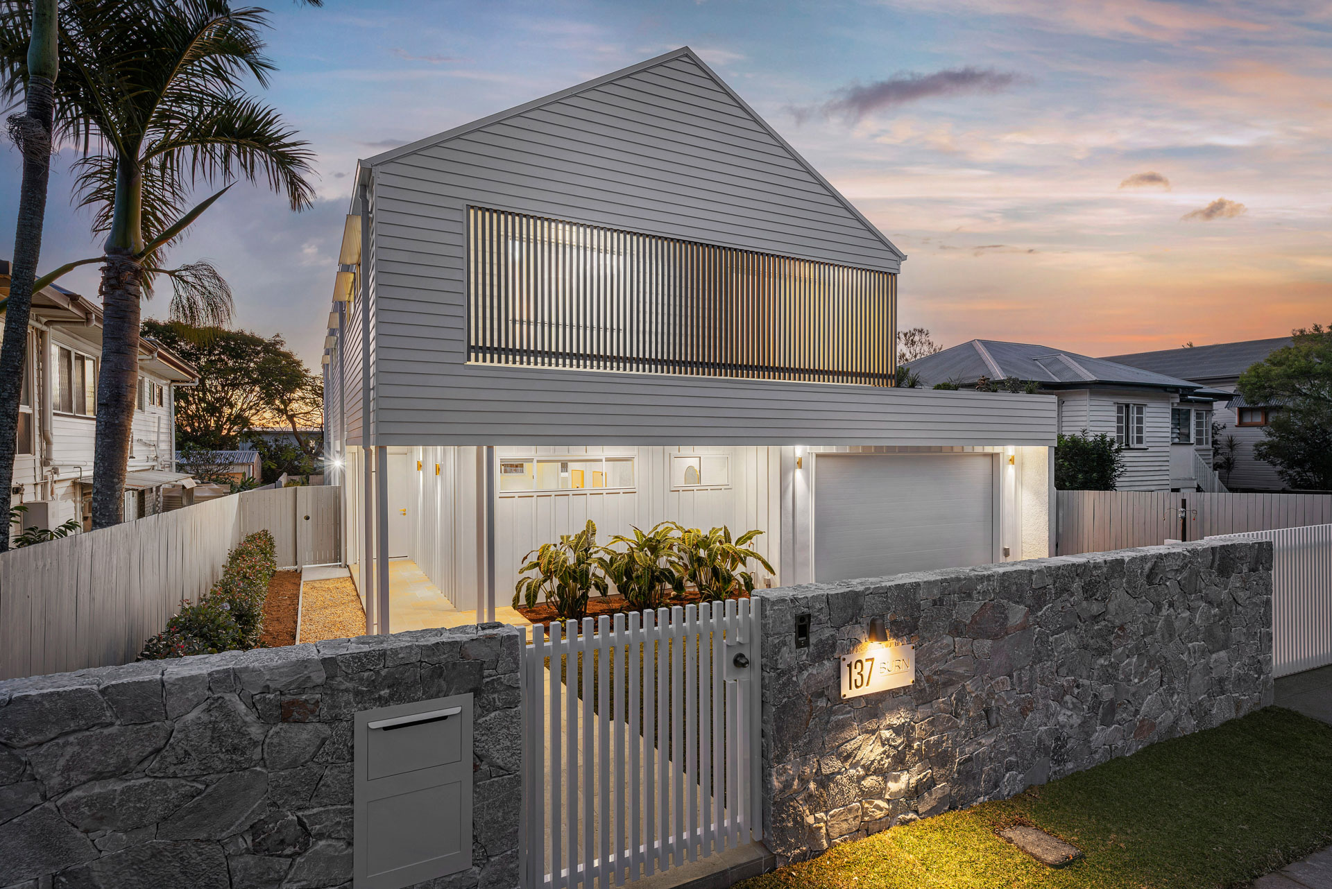 Completed custom home facade at dusk