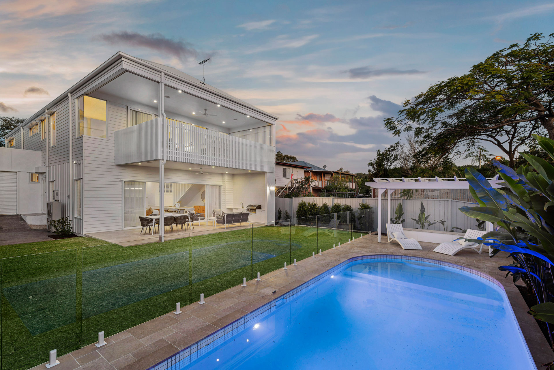 Rear elevation and pool at dusk