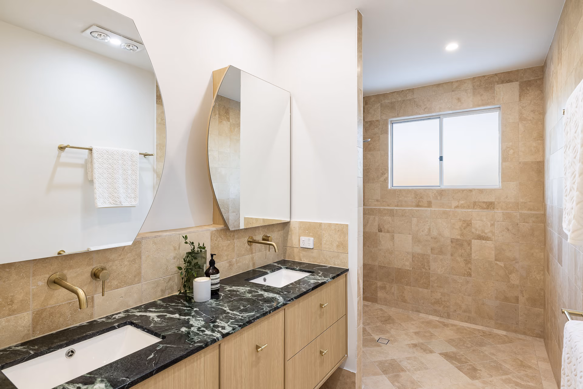 Bathroom with travertine tiling and stone vanity