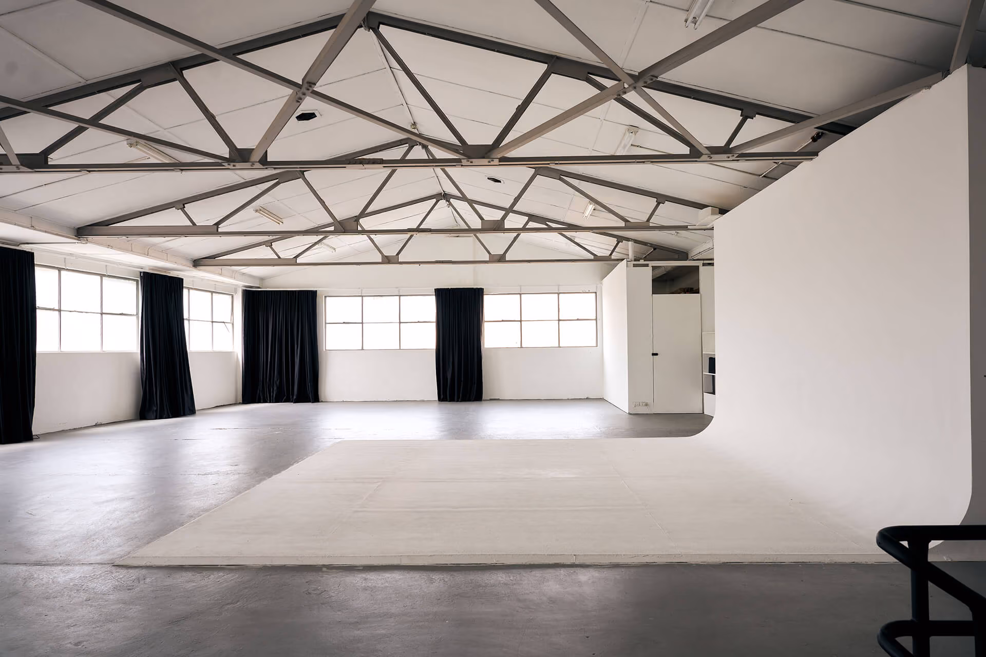 Frank, a large and brightly lit photography studio flooded with natural light.