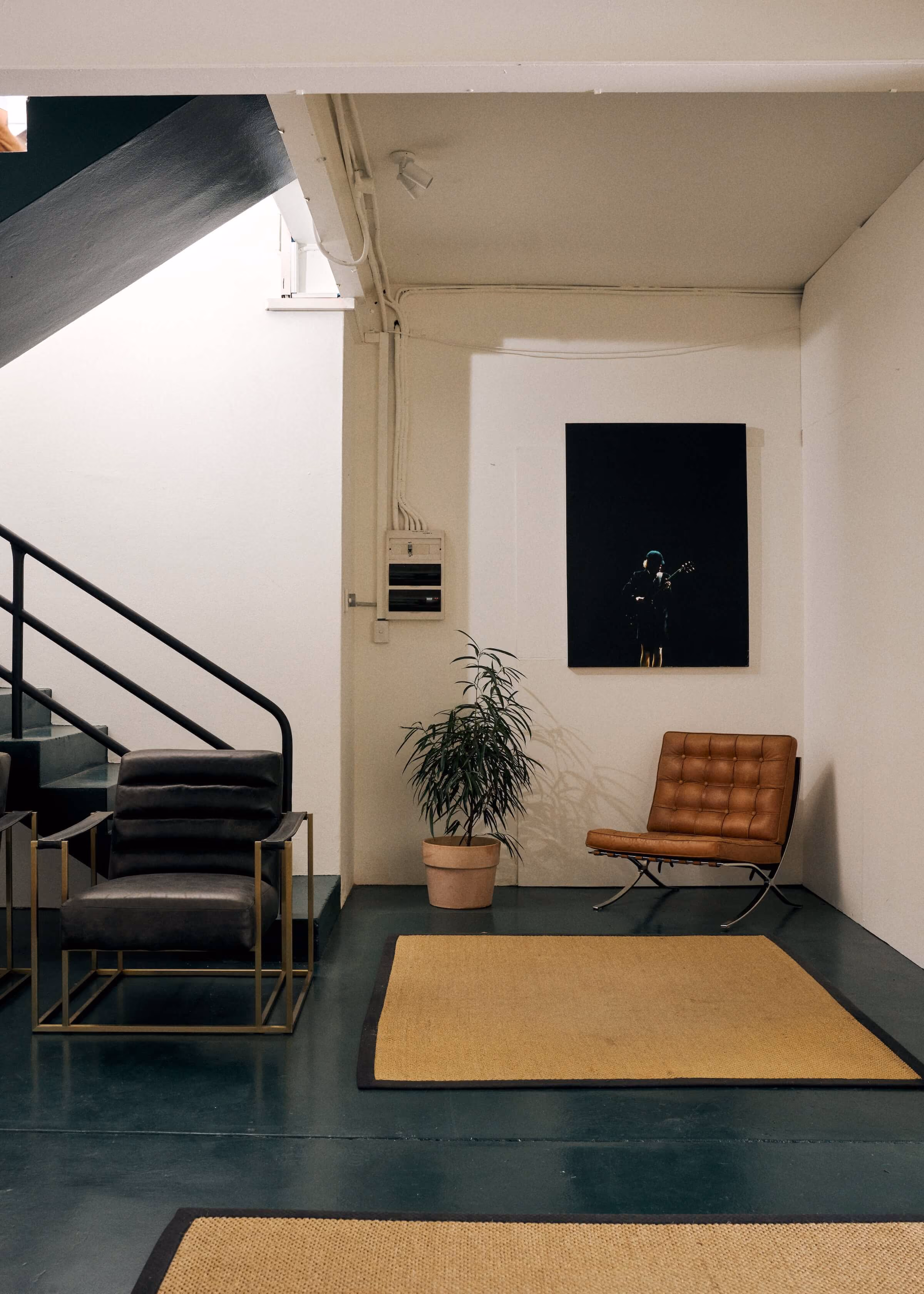 A sitting area at the bottom of the stairs of Frank the Studio