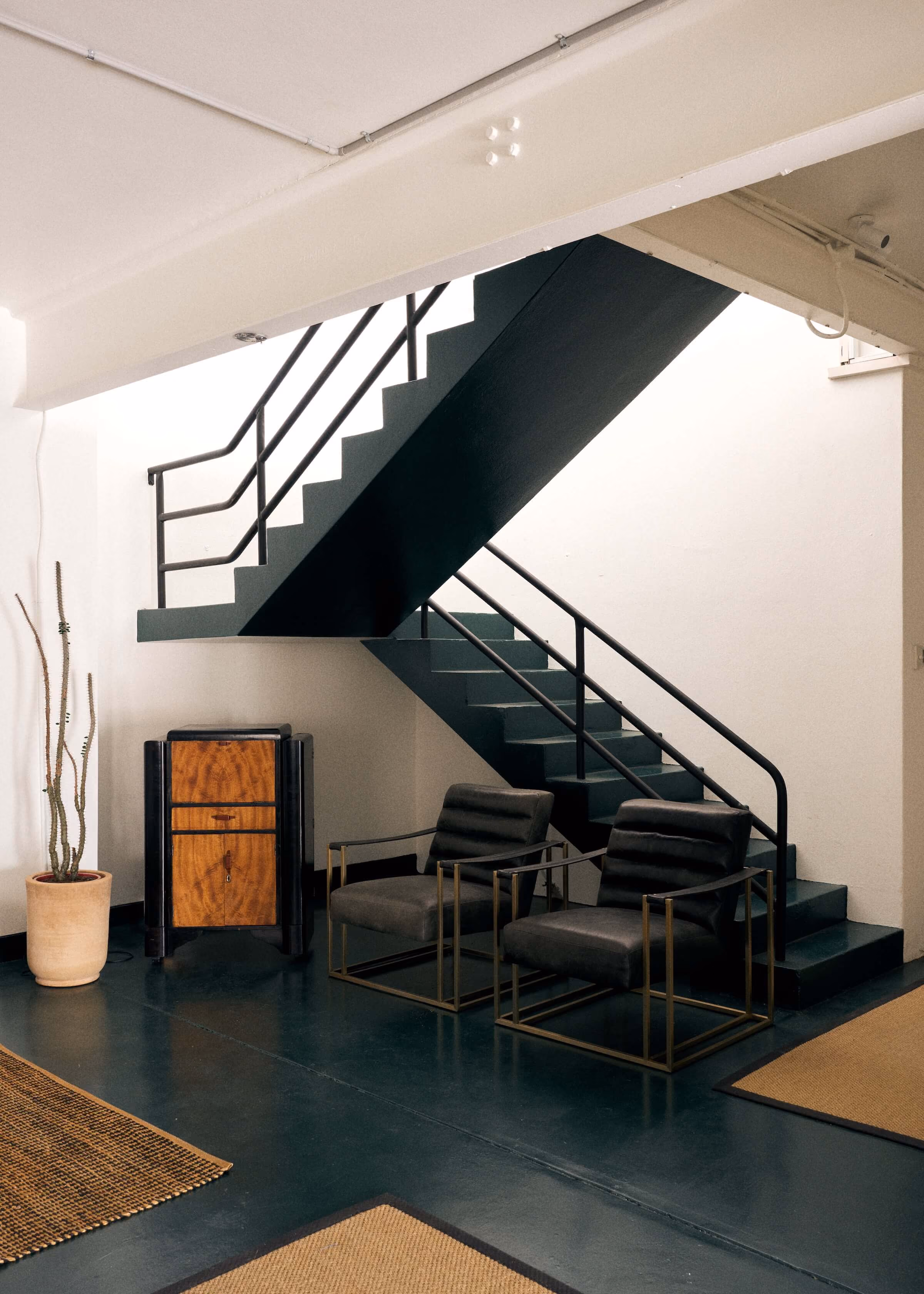 A waiting and lounge area below the stairs that lead up to Frank the studio