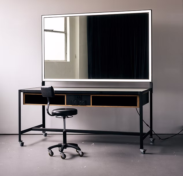 A movable make-up station with stool, bench and large mirror