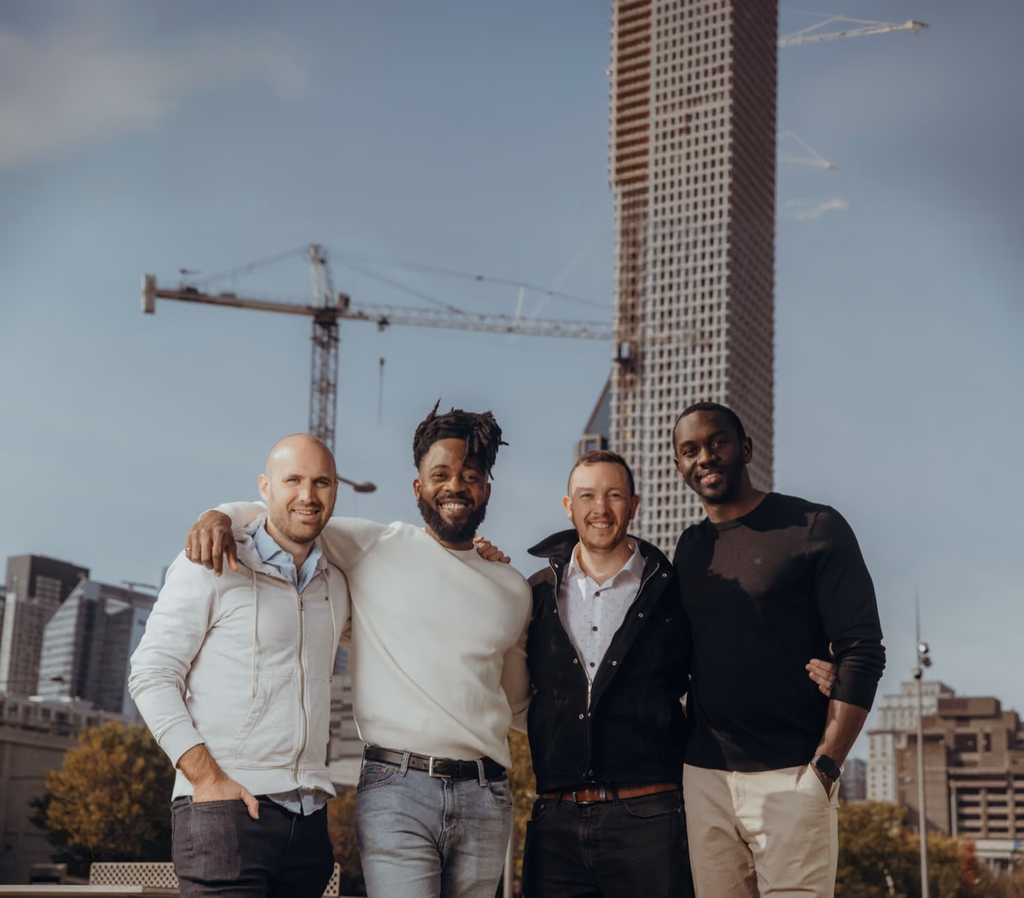 Four members of the Billdr team standing together on a construction site