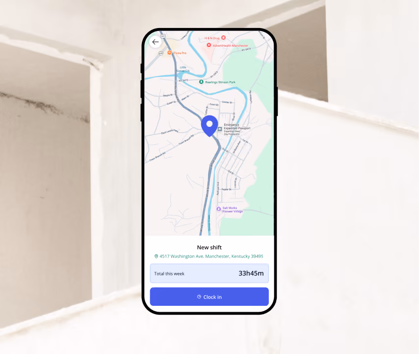 Smartphone screen showing a map with a blue location pin marking 4517 Washington Ave, Manchester, Kentucky 39495, and a time tracking app interface displaying a new shift, total hours this week as 33h45m, and a blue Clock in button.