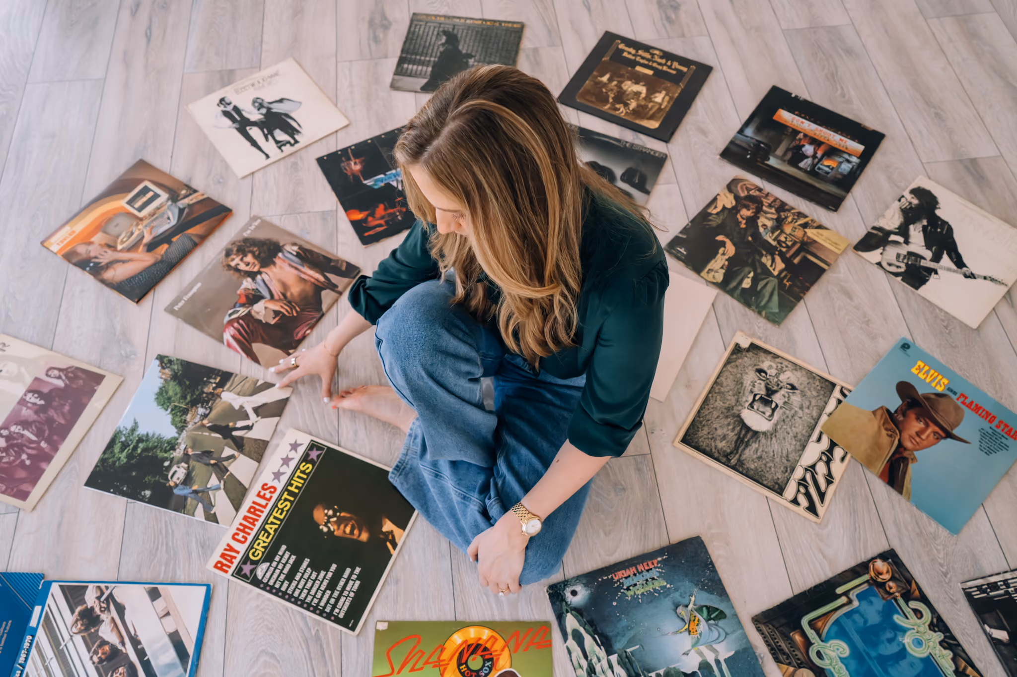 Kaitlyn sitting on the floor surrounded by records