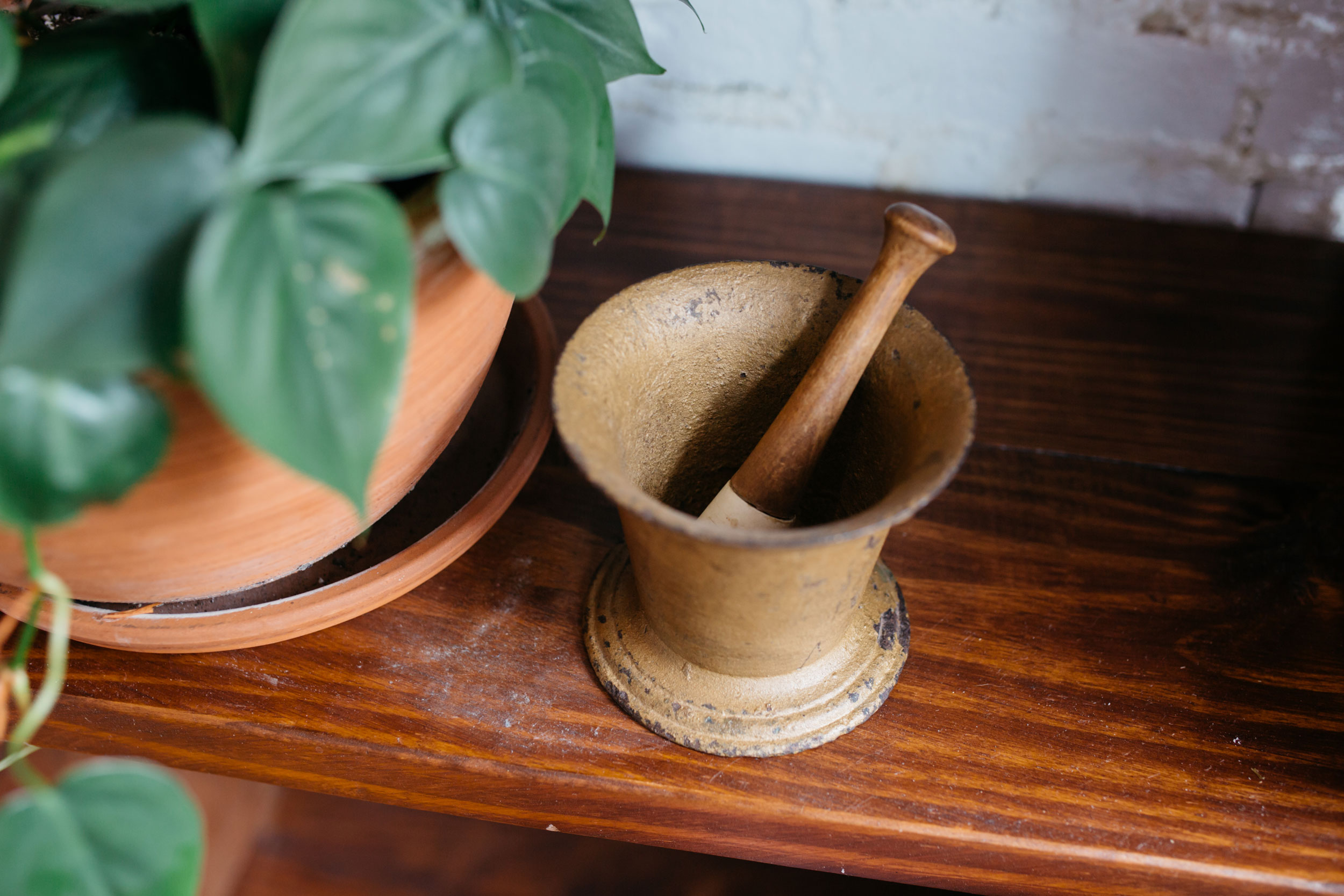 Hero header banner displaying a wooden mortar and pestle on a table alongside potted plants, titled "About Hometown Health System."