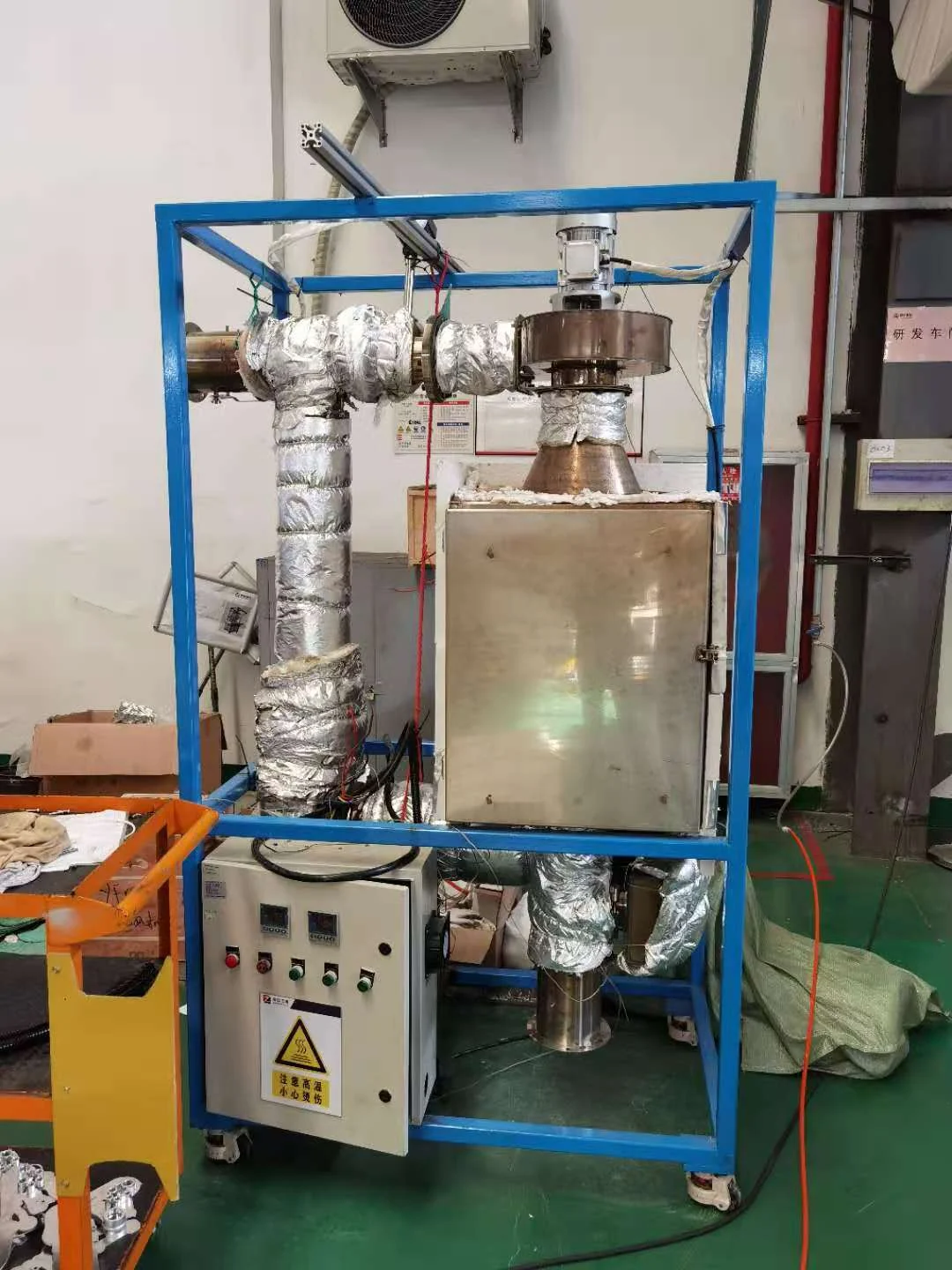 Side view of the original thermal circulation regeneration system with exposed piping and separate control equipment