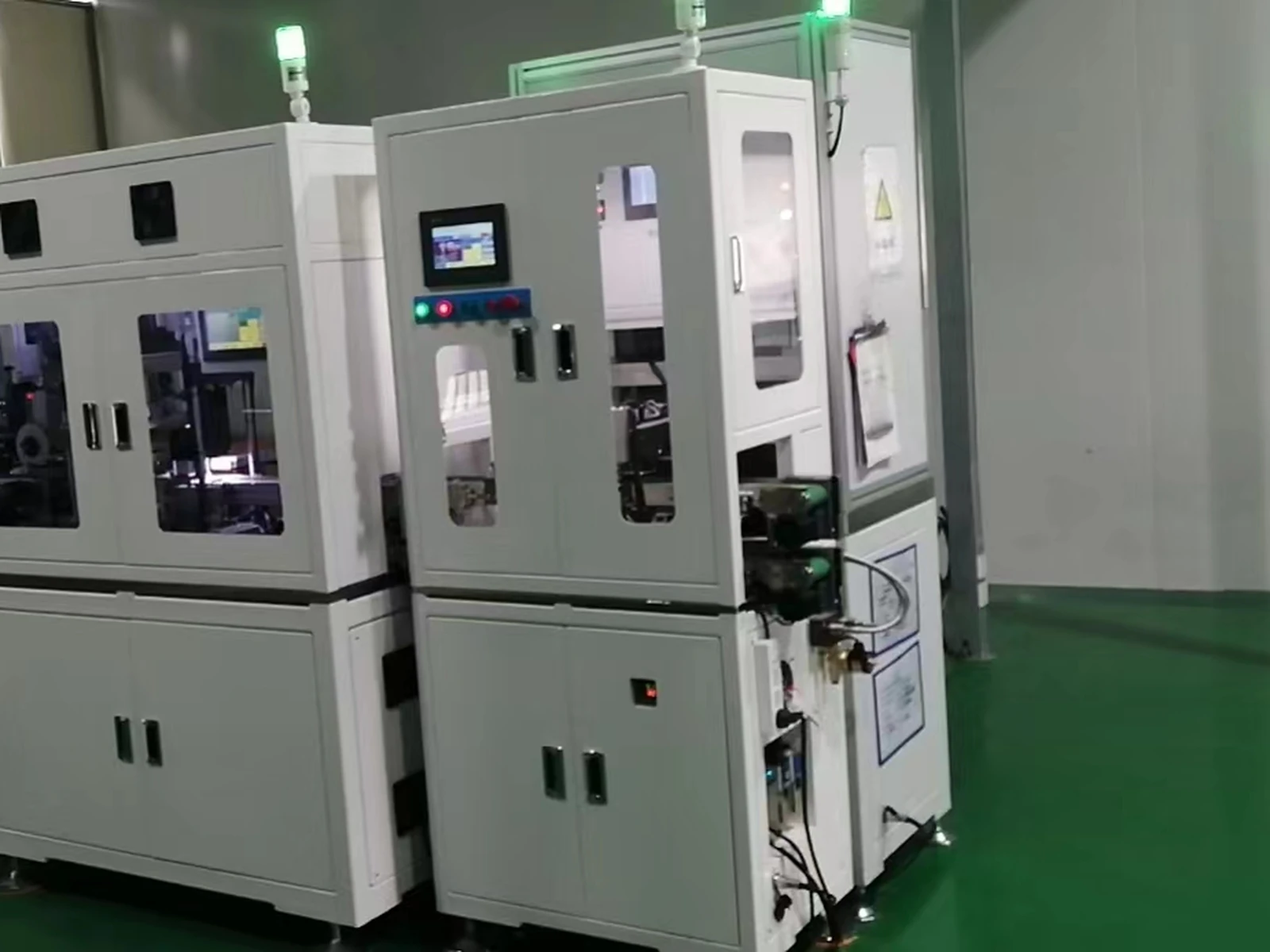 Original winding machine before exterior redesign with white sheet-metal enclosure, observation windows, access doors and control interface.