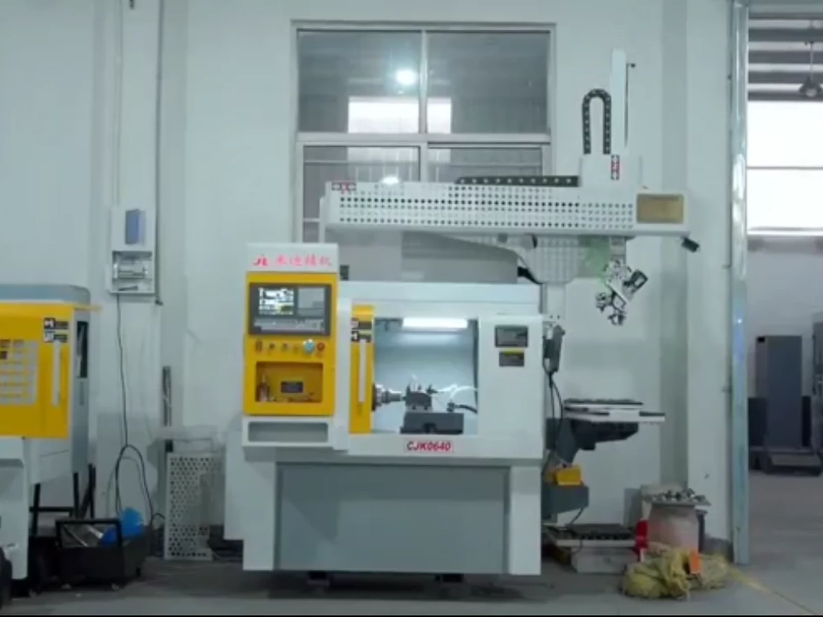 Original gantry loading and unloading robot system before redesign, showing exposed beam structure, cable chain, machine tool and material handling area.