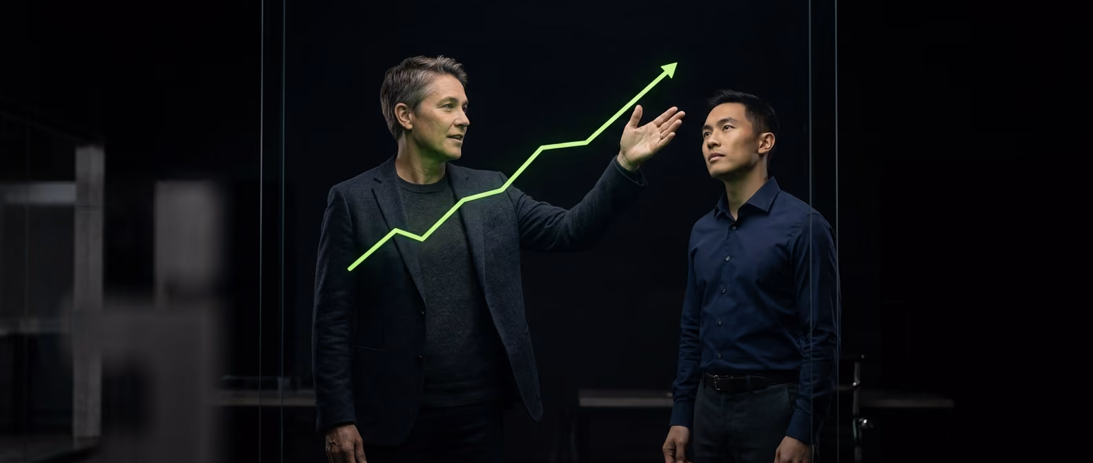 An advisor and founder reviewing an upward-trending forecast projection glowing in lime-green on a screen together