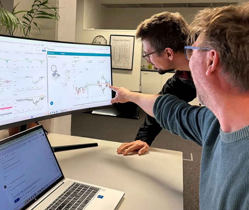 Two LIFEPOWR colleagues reviewing energy data on a screen