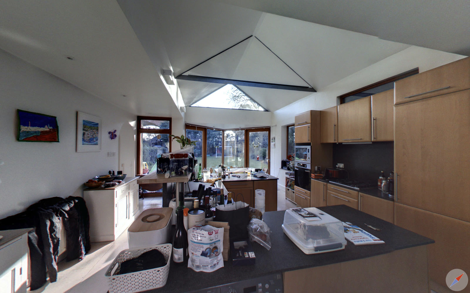The old kitchen with dark timber units beneath a pyramid roof lantern