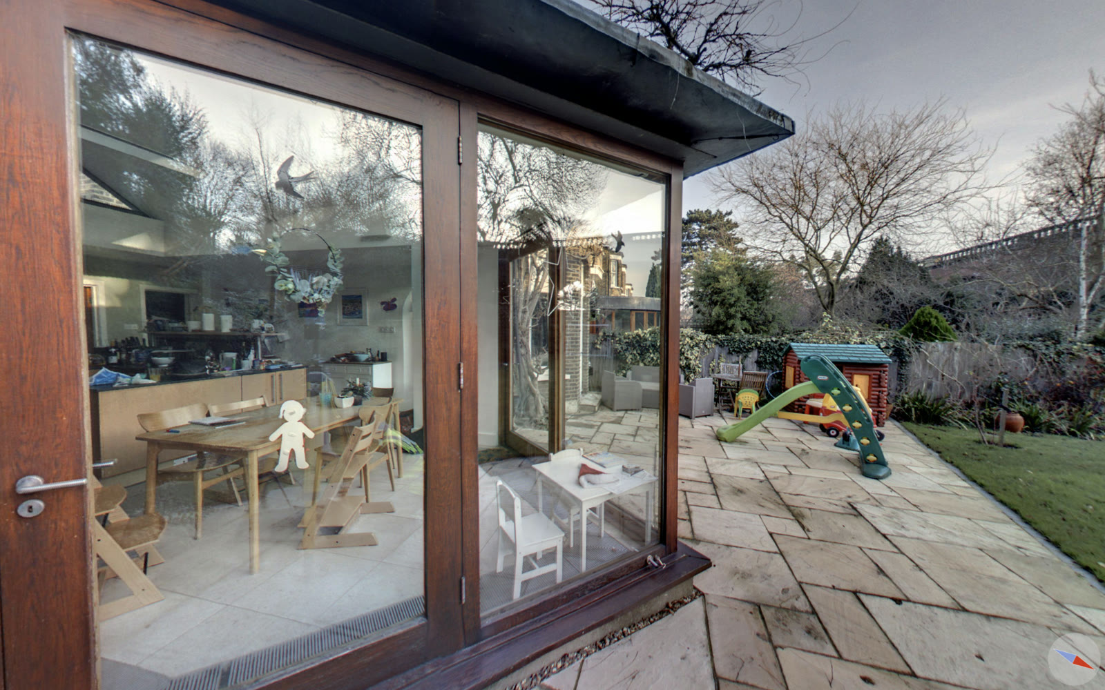 Looking out to the patio through heavy brown timber doors before the work