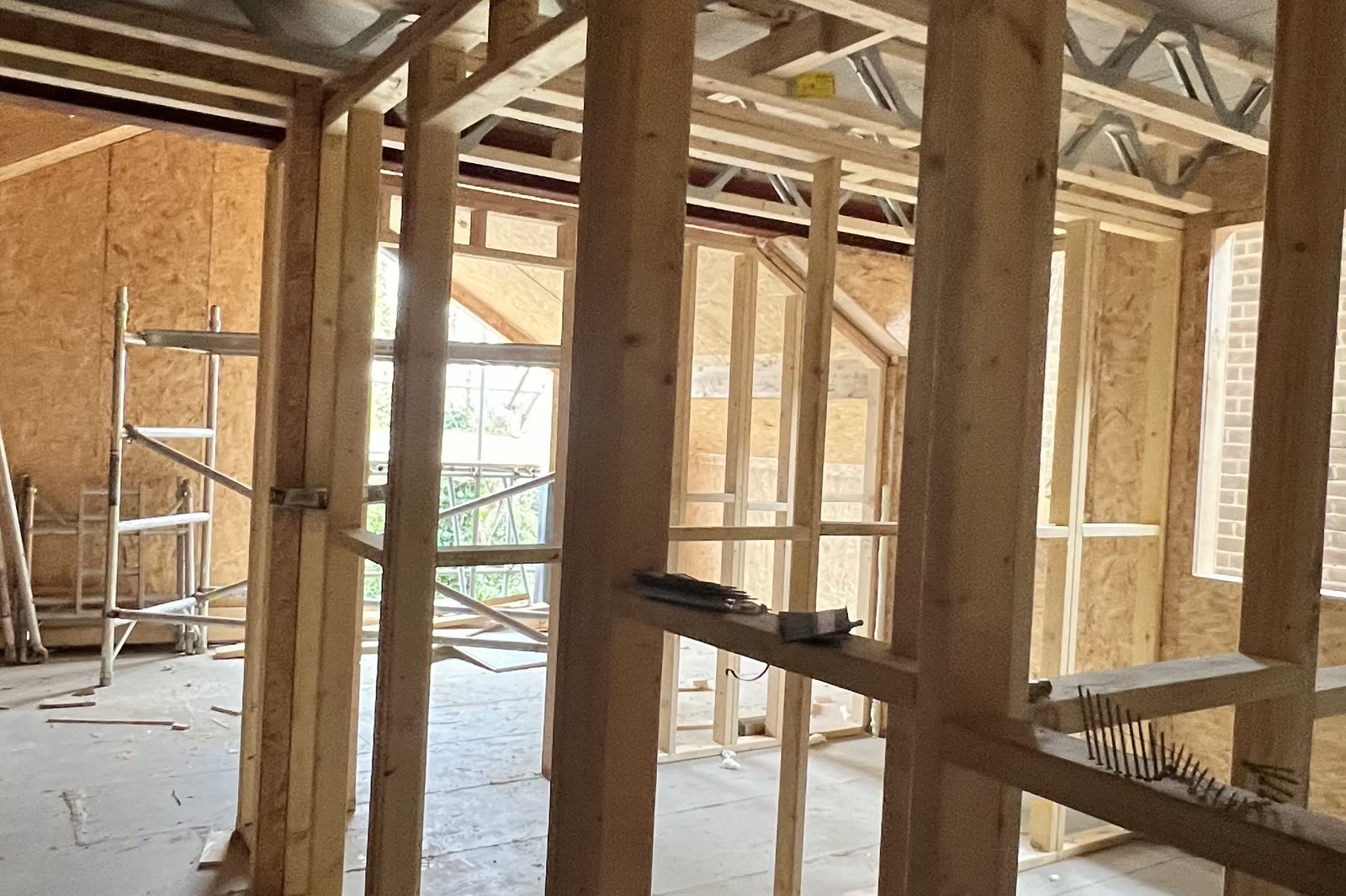 The ground floor in timber frame, stud partitions standing on the slab