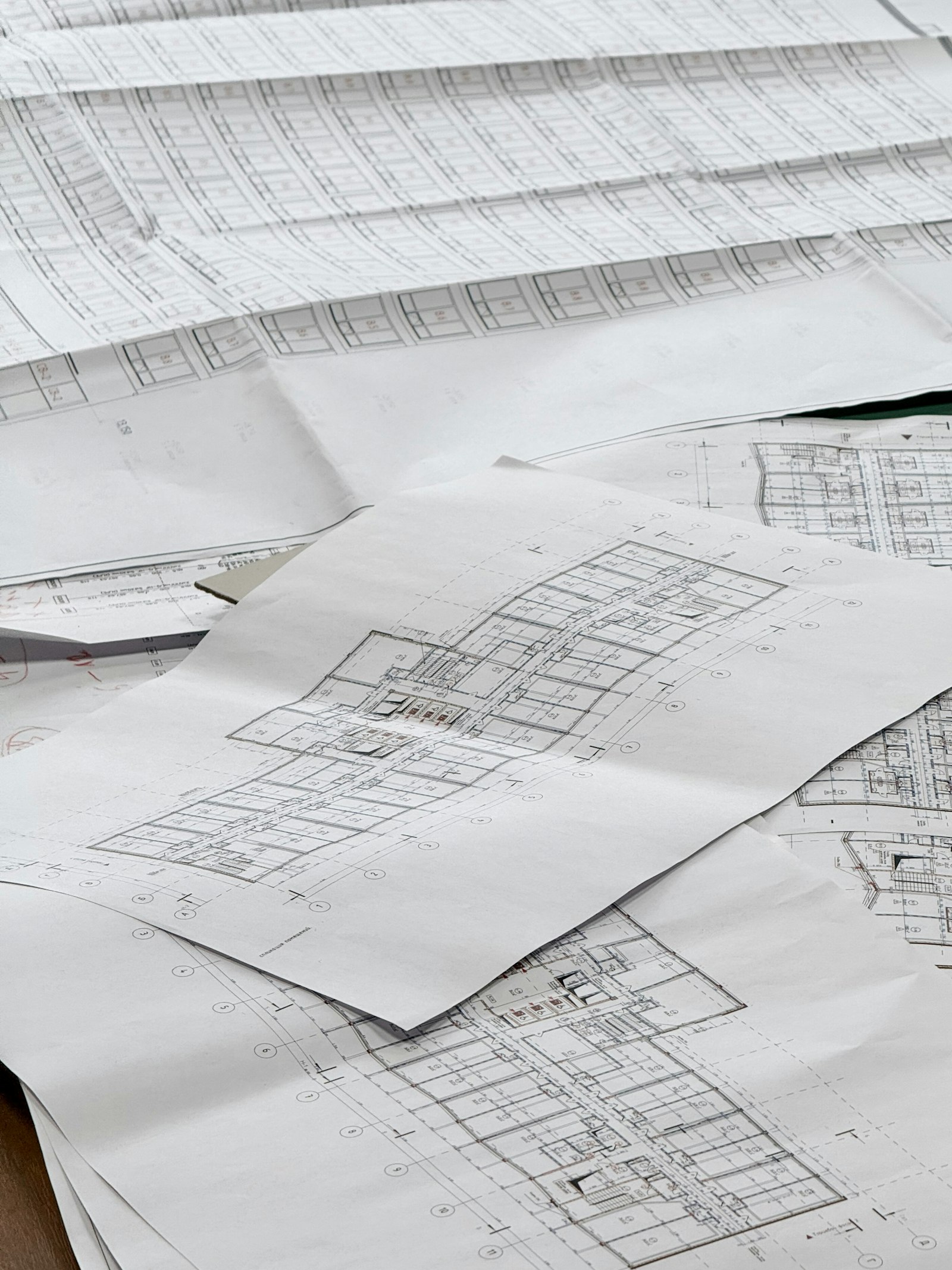 Construction drawings spread on a table during preconstruction review | Westside Construction Group