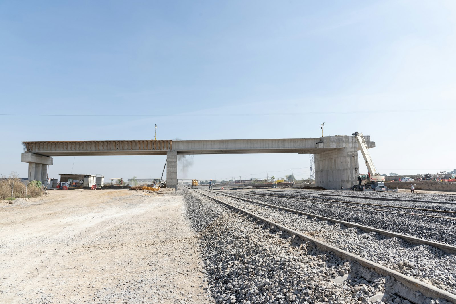 Rail line with a bridge in the background | Westside Construction Group