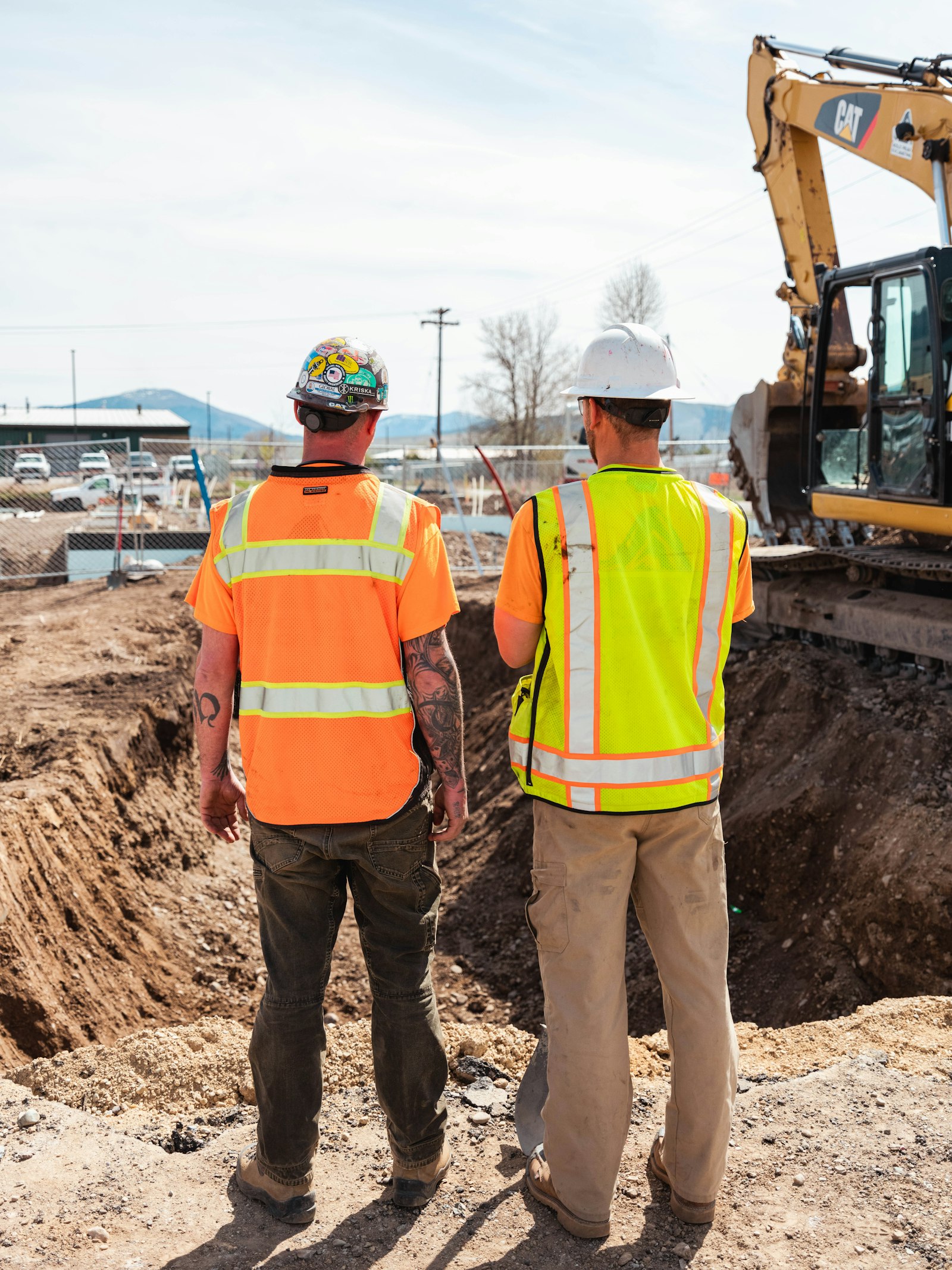 Crew in safety vests in front of a construction vehicle | Westside Construction Group