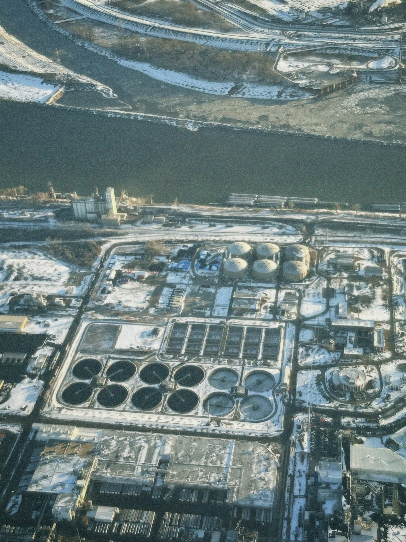 Aerial view of an industrial complex along a river | Westside Construction Group