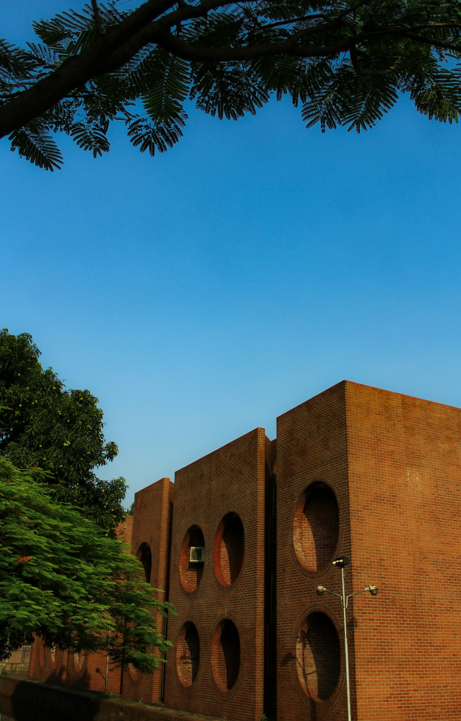 Brick school building with circular windows | Westside Construction Group