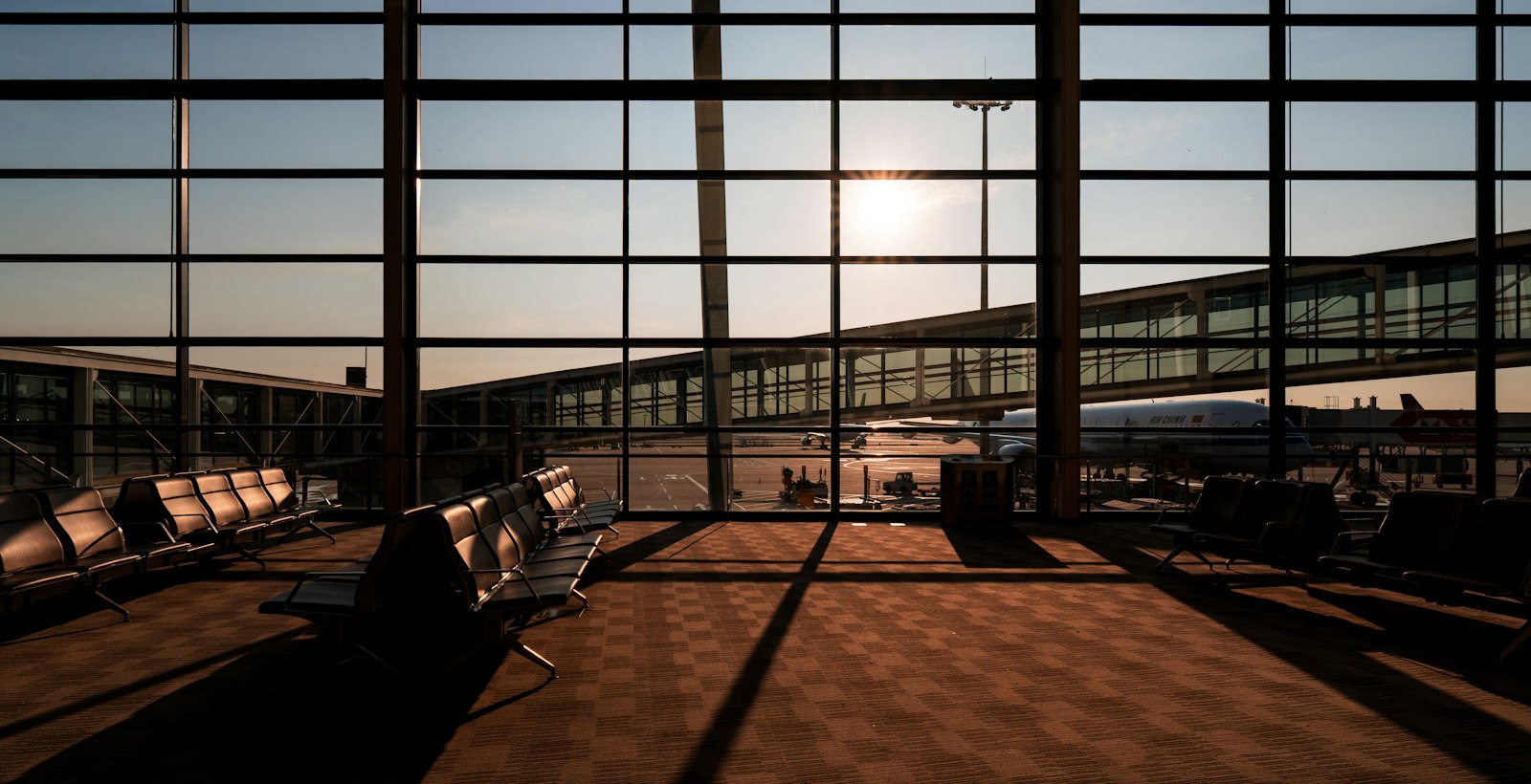 Airport terminal gates with jet bridges at sunset | Westside Construction Group