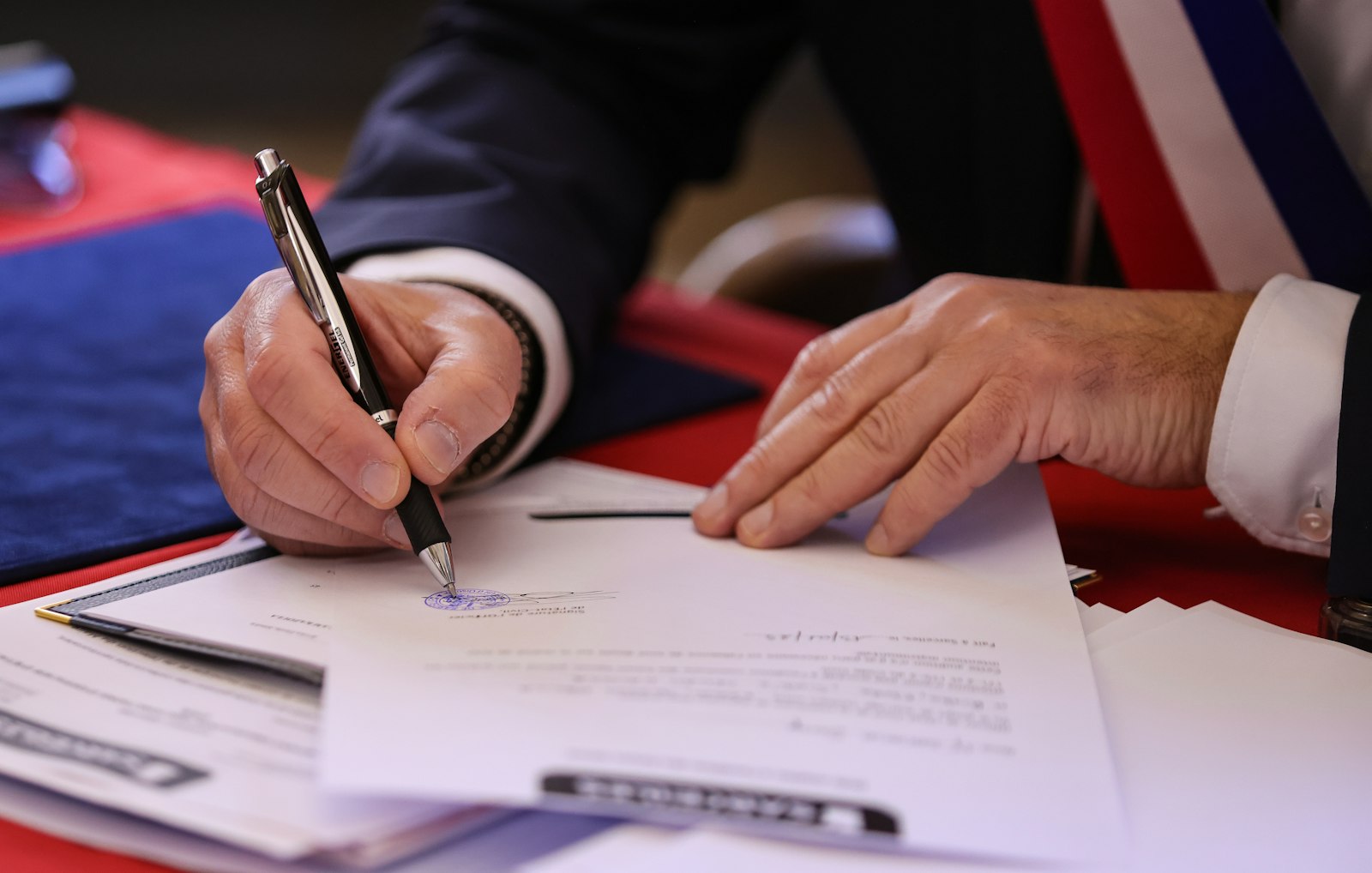 Signing a legal document with a pen | Westside Construction Group