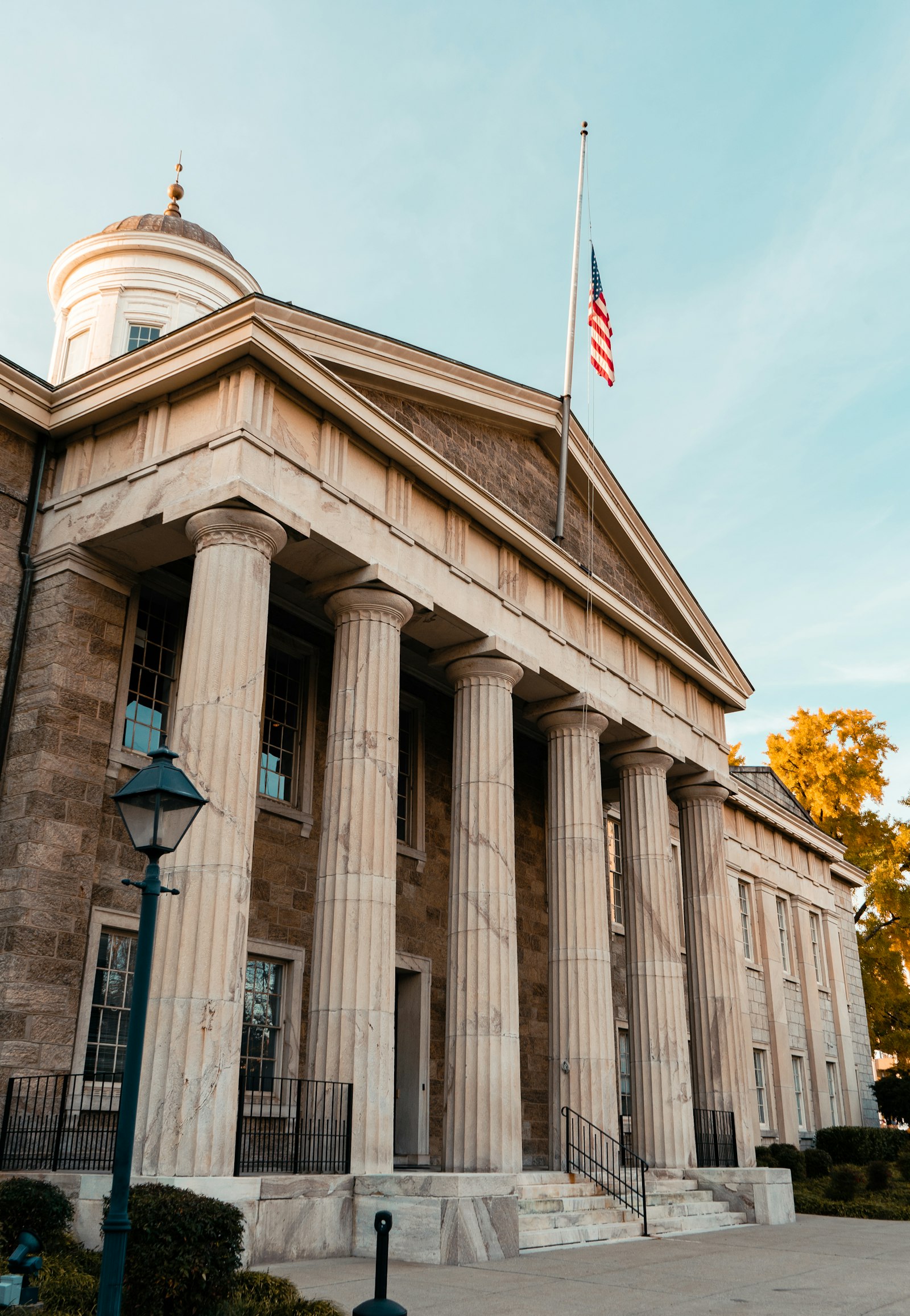 Government building with columns and a flag | Westside Construction Group
