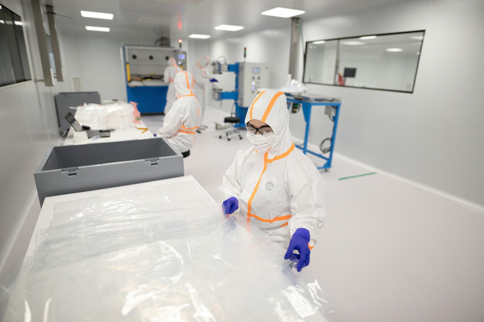 Workers in protective suits inside a clean room | Westside Construction Group
