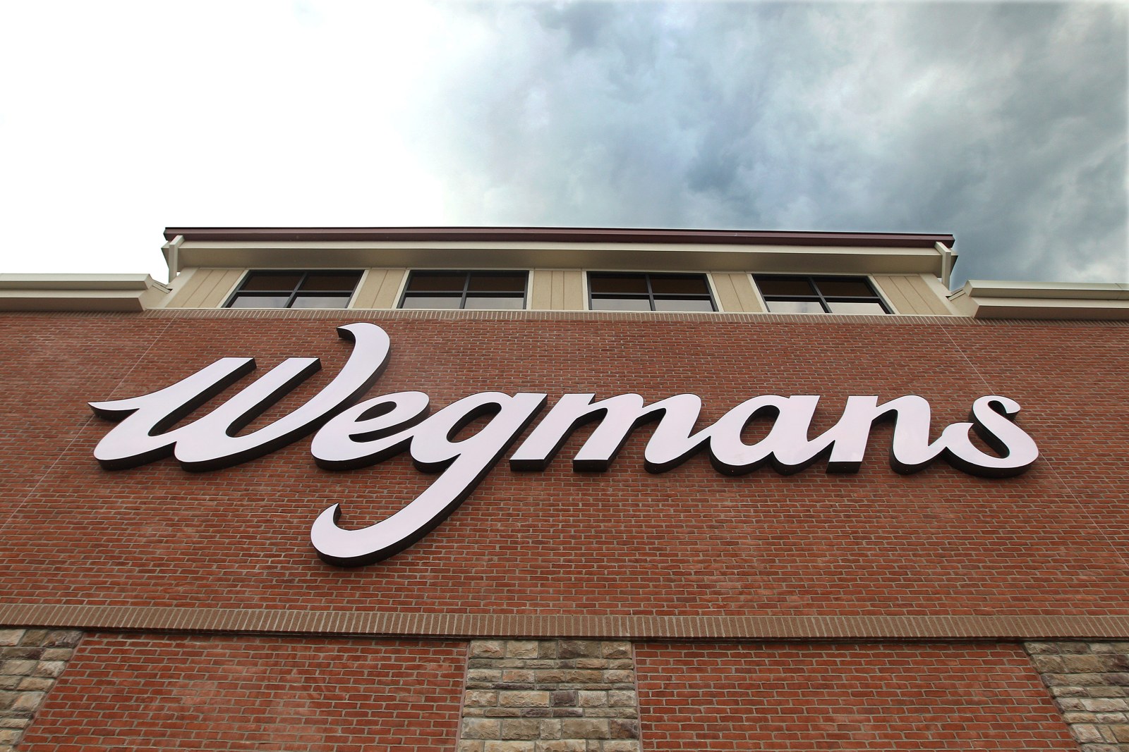 Wegmans store sign on a brick facade