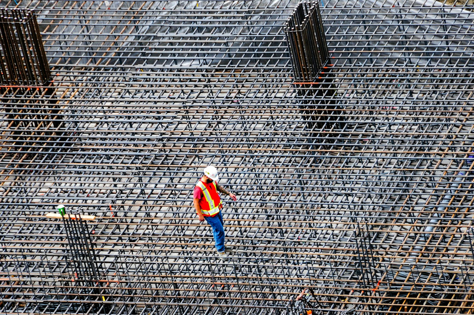 Construction worker inspecting rebar on a building site | Westside Construction Group